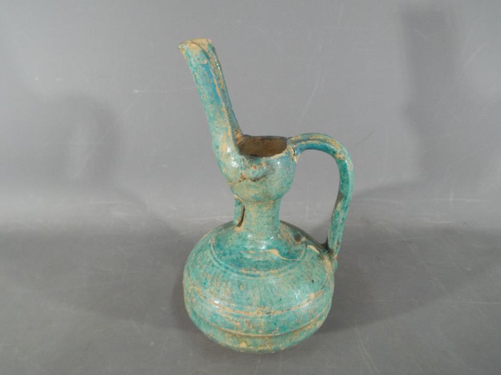 A rare middle eastern turquoise glazed jug of waisted globular form with elongated pouring spout, - Bild 4 aus 8