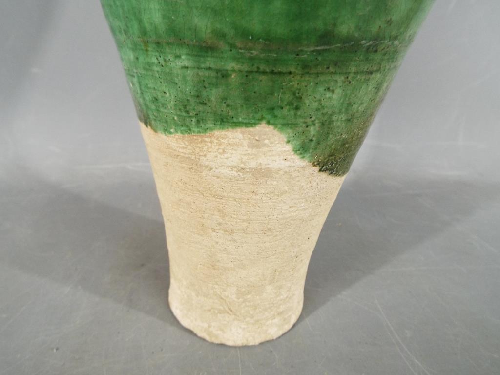 A Chinese Tang dynasty sancai glaze vase of mis-shapen form, unglazed to lower section, - Image 5 of 8