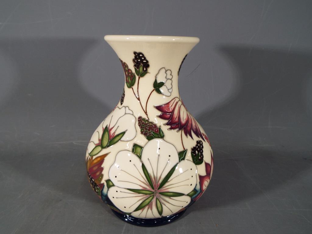 Moorcroft Pottery - a vase decorated in the Bramble Revisited pattern,