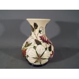 Moorcroft Pottery - a vase decorated in the Bramble Revisited pattern,