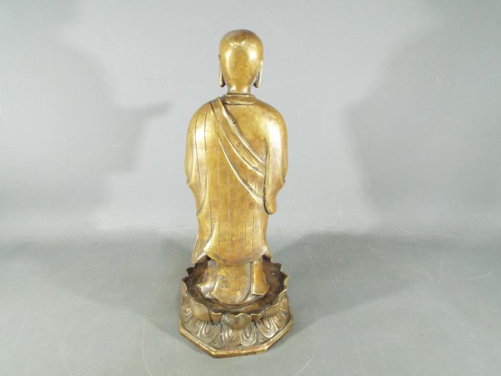 A rare, Chinese Tibetan large gilt bronze depicting Ananda, standing on a lotus base, - Image 4 of 6