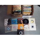 Two boxes containing a quantity of 45 RPM vinyl records to include The Style Council, Soft Cell,