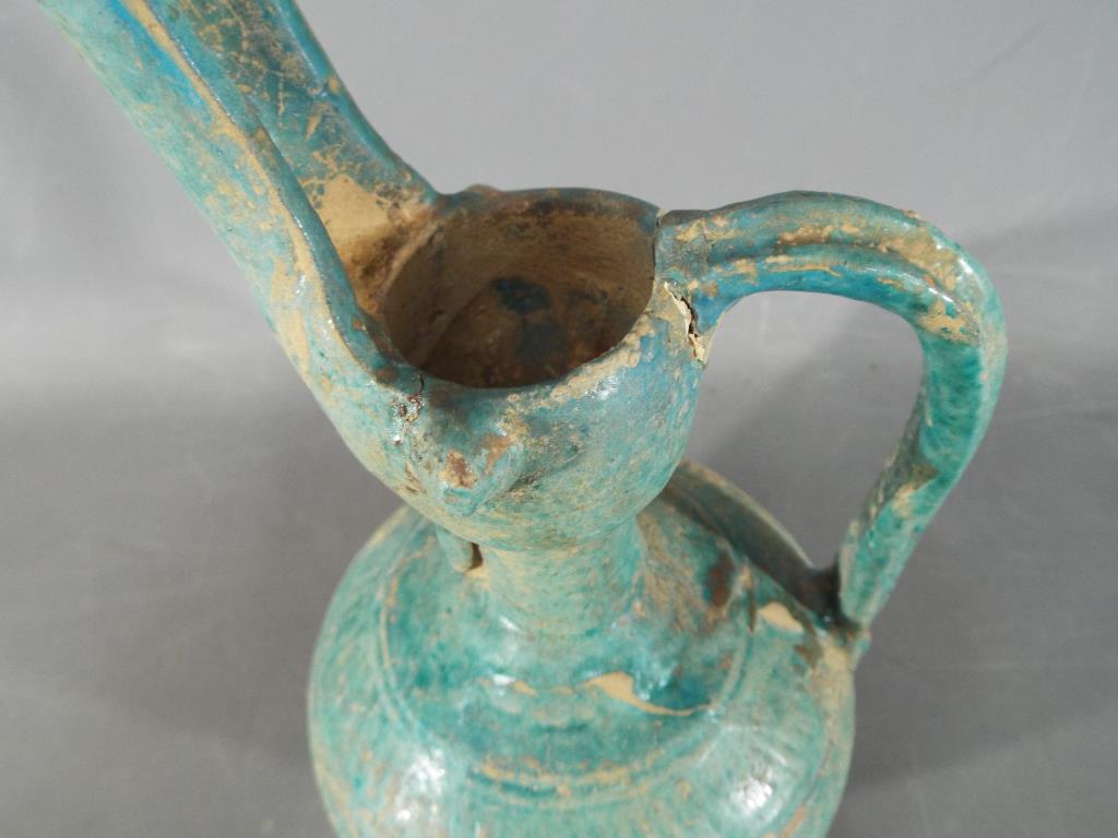 A rare middle eastern turquoise glazed jug of waisted globular form with elongated pouring spout, - Bild 5 aus 8