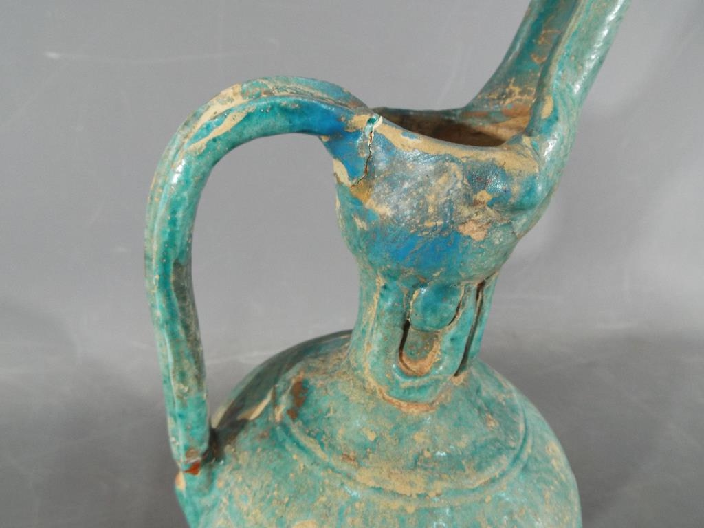 A rare middle eastern turquoise glazed jug of waisted globular form with elongated pouring spout, - Image 2 of 8