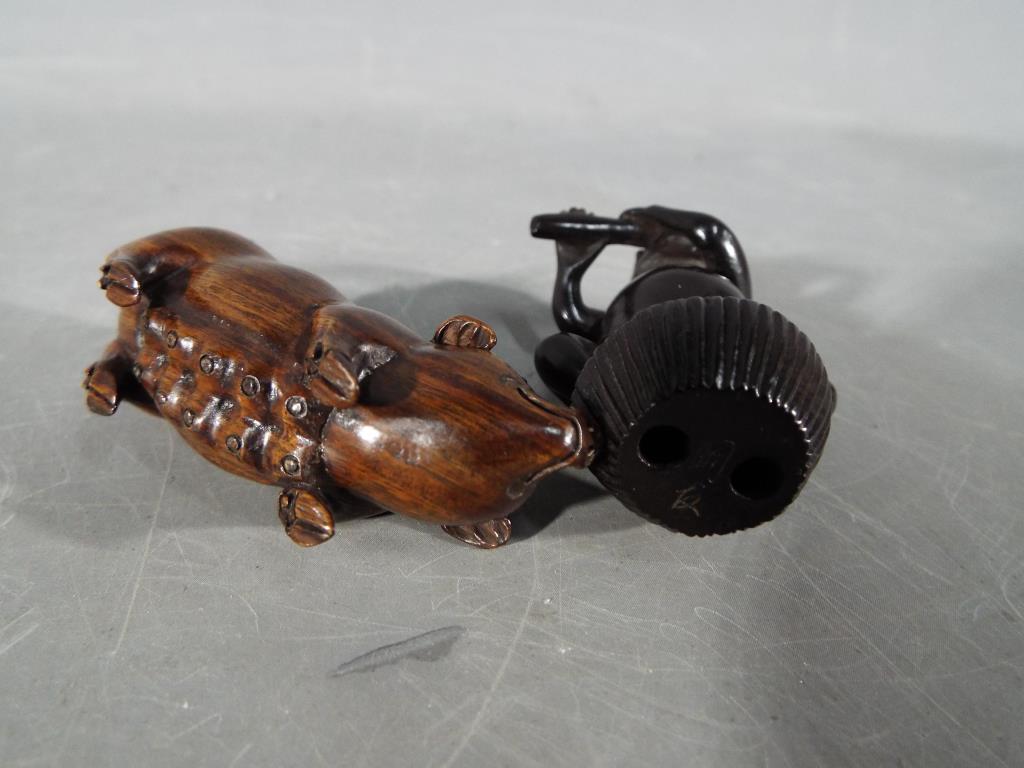 A vintage Japanese dark wood Netsuke depicting a frog type creature possibly playing a flute, - Image 3 of 3