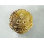 A small Chinese Tibetan russet jade carving depicting a seated Buddha with twin carved phoenix