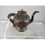 A small good quality bronze teapot decorated with birds and stylised flowers, with cover,