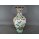 A Chinese enamelled vase with floral and bird decoration, ruyi border to the neck, approximately 30.