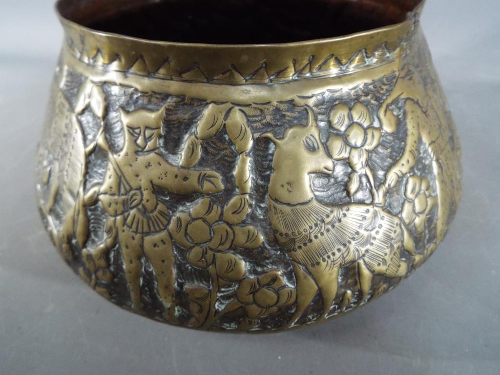 A middle eastern gilt bowl with repoussé decoration depicting fauna and mythical creatures, - Image 4 of 8