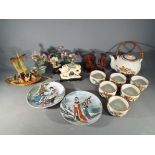 A hand painted Chinese tea set, carved wooden figures, plates,