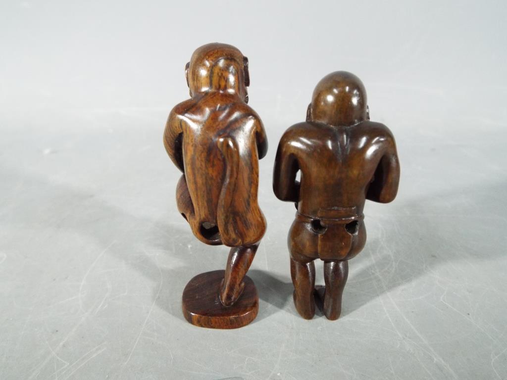 A vintage dark wood Japanese erotic Netsuke depicting an Oriental gentleman, - Image 2 of 3