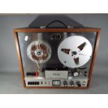 A vintage TEAC A-1500-W reel to reel recorder.