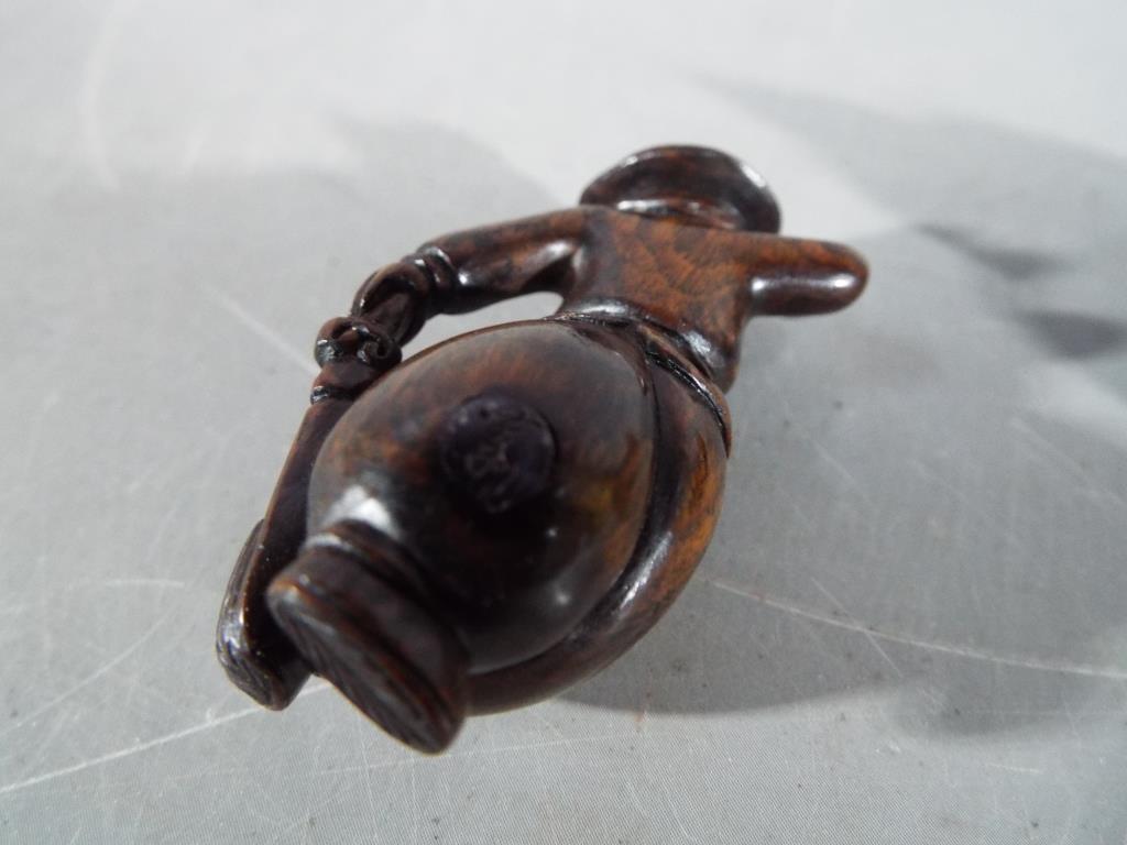 A vintage Japanese dark wood Netsuke depicting a large mouse or rat carrying its catch, - Image 5 of 5