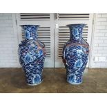 A very large pair of Chinese vases with everted rim and decoration depicting a seascape with