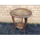 A highly carved Japanese oak tripod table with dragon top decoration and lower gallery,