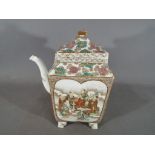 A Chinese square form teapot, raised on four supports,