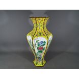 A Chinese early 20th century Canton enamel vase of hexagonal and baluster form with flaring neck,