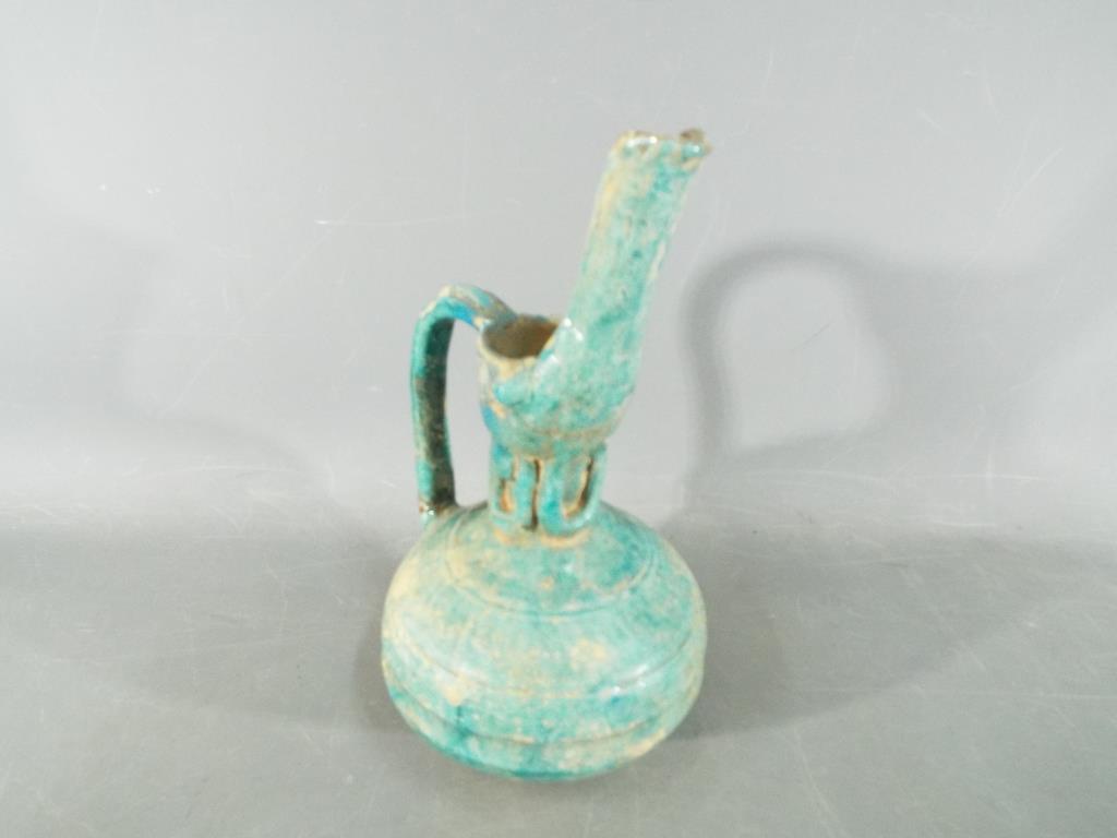 A rare middle eastern turquoise glazed jug of waisted globular form with elongated pouring spout, - Bild 3 aus 8