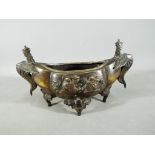 A Chinese gilt bronze censer raised on four supports with twin phoenix handles,