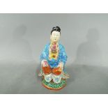 A rare 18th century, Chinese, famille rose figurine depicting a scholar or possibly Guanyin,