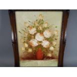 A framed oil on canvas still life of flowers, signed lower right by the artist,