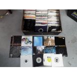 A box containing a large quantity of 45 RPM vinyl records to include 10cc, ELO, Styx,