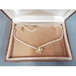 A cultured pearl necklace of 90 pearls with 18ct diamond set flower drop pendant,