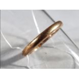 A 22ct gold wedding band, size K 1/2, approximately 2.75 grams total weight.