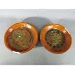 A pair of rare Chinese Tang dynasty sancai glaze terracotta dishes raised on tripod supports with