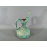 A rare middle eastern turquoise glazed jug of waisted globular form with elongated pouring spout,