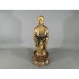 A rare, Chinese Tibetan large gilt bronze depicting Ananda, standing on a lotus base,