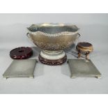 A collection of Chinese wooden and pewter stands along with a large metal bowl with chased