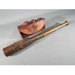 A brass and leather telescope marked Dolland of London