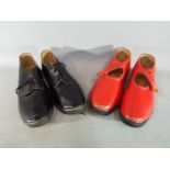 Two pairs of good quality leather clogs.