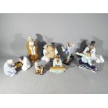 Eight modern, Chinese buff coloured stoneware figurines, part glazed, marked Made In China,