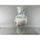 A large Chinese famille rose baluster vase decorated with a battle scene (possibly the battle of