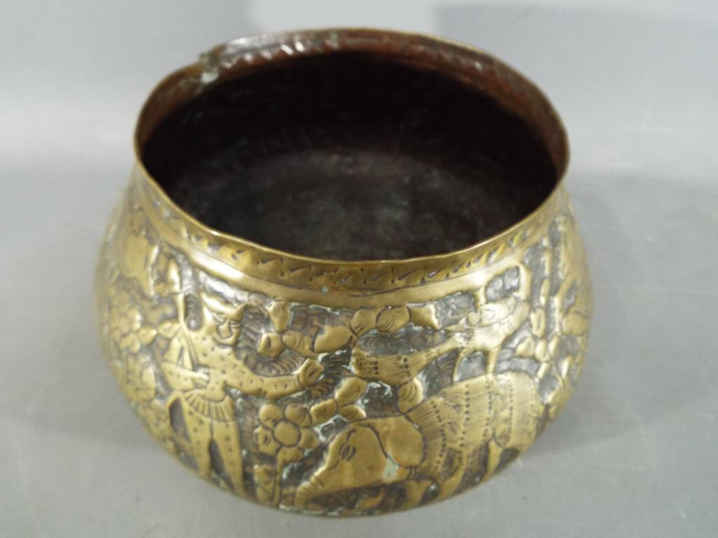 A middle eastern gilt bowl with repoussé decoration depicting fauna and mythical creatures, - Image 2 of 8