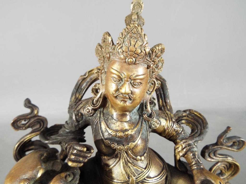Buddha - An 18th / 19th century Chinese Tibetan gilt bronze Buddhist figure depicting Jambhala - Image 2 of 5