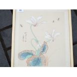 A framed watercolour and ink painting depicting flowers and insects, signed to the left,