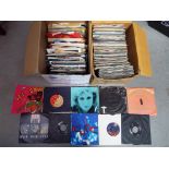 Two boxes containing a quantity of 45 Rpm vinyl records to include The Who, T-Rex, The Cure,