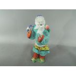 A Chinese 19th century famille rose figure depicting an Immortal,