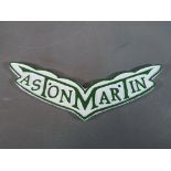 A cast sign marked Aston Martin