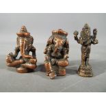Three small Indian figurines depicting Ganesha,