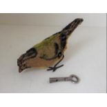 An early 20th century model of a bird having an internal clockwork mechanism, with key,