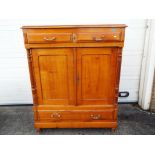 A large sideboard having two drawers over twin doors and a larger lower drawer,