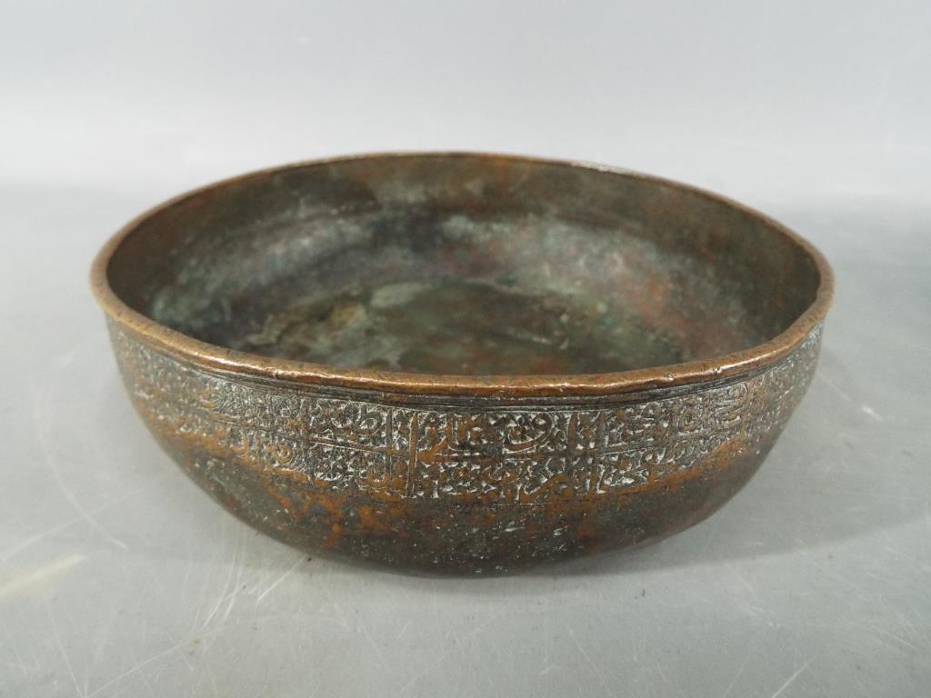 A Persian 14th century Timurid, tinned copper bowl of deep rounded form with slightly everted rim,