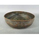 A Persian 14th century Timurid, tinned copper bowl of deep rounded form with slightly everted rim,