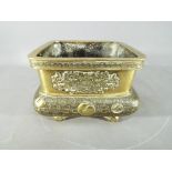 A 19th century gilt bronze, Chinese or Japanese square form censer, raised on four supports,