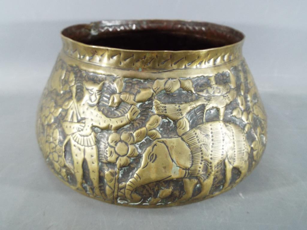 A middle eastern gilt bowl with repoussé decoration depicting fauna and mythical creatures, - Image 8 of 8