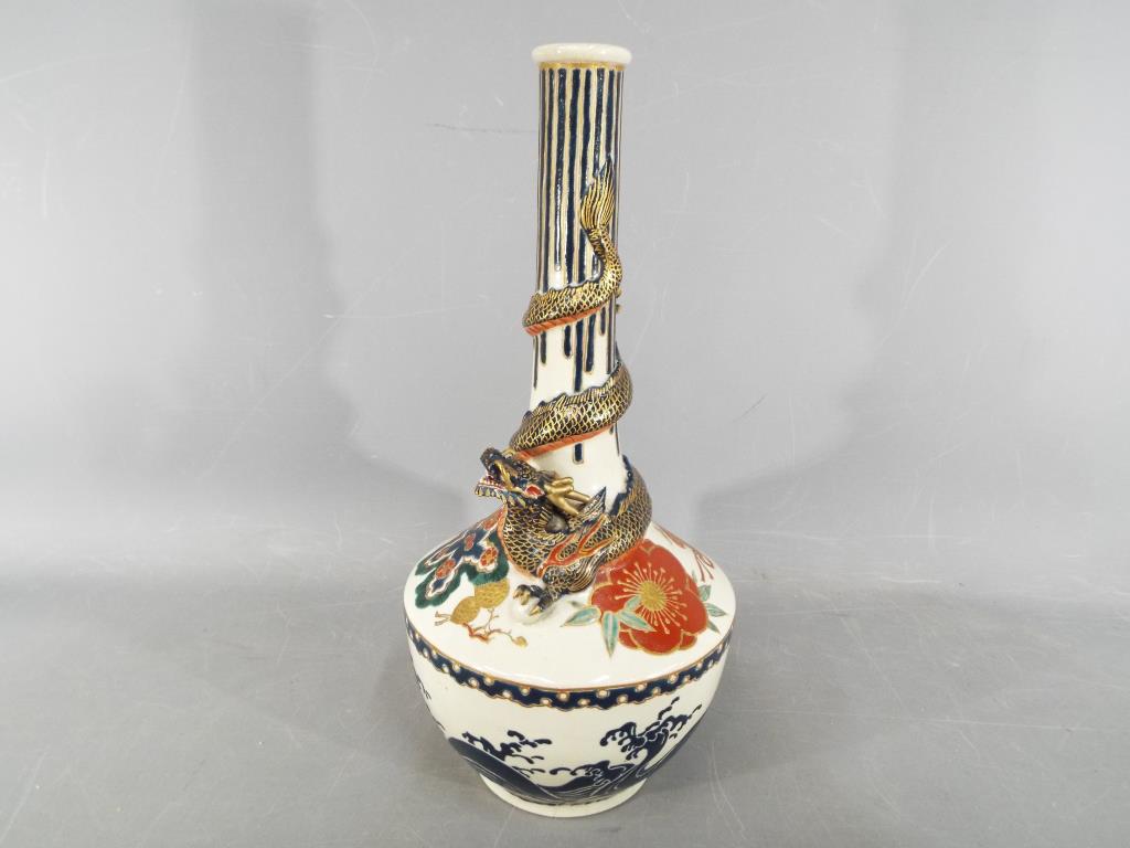 An unusual Meiji period Satsuma bottle vase by Kintozan with applied dragon coiled around the neck